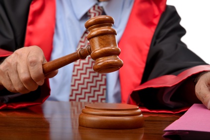 Judge striking the gavel to keep silence